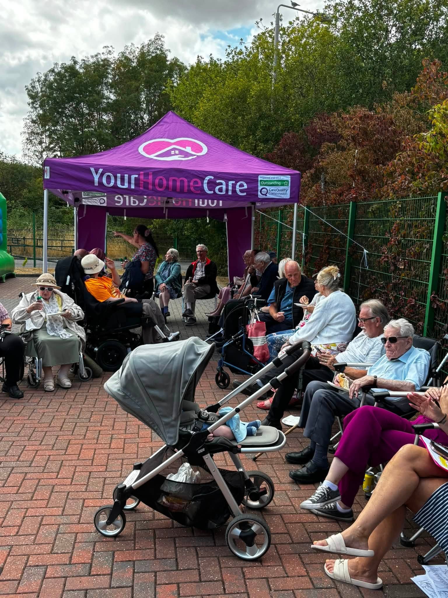 Guests enjoying the annual BBQ beside the Your Home Care gazebo