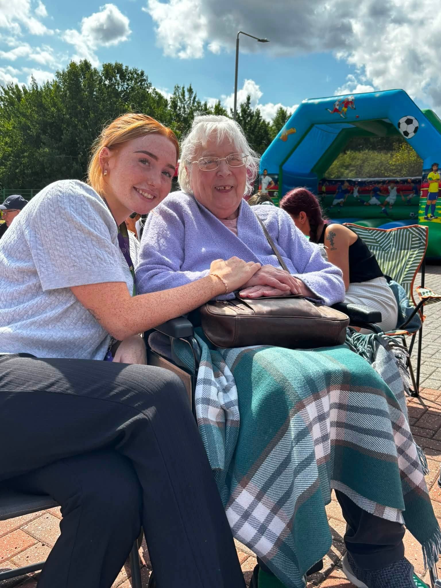 A care team member spending time with a client at the annual BBQ