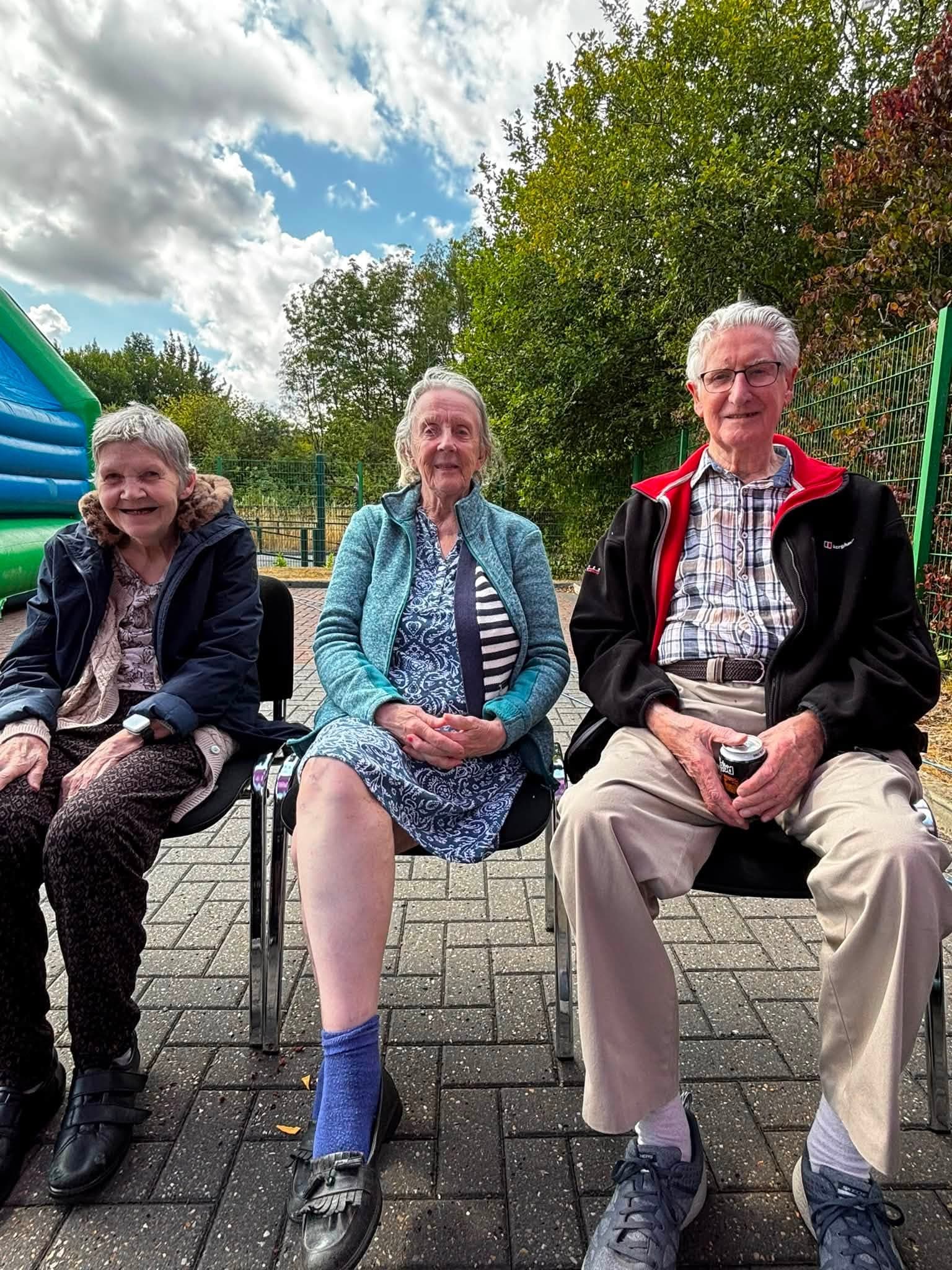 Three Your Home Care clients enjoying the outdoor celebration